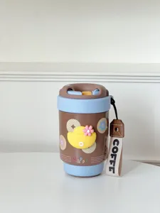 Close-up of cute ceramic insulated coffee cup with duck decor and convenient strap detail.