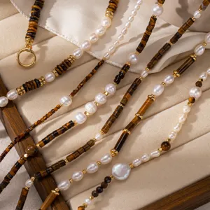 Layered pearl and tiger eye stone beaded necklace with 18k gold plated metal details.