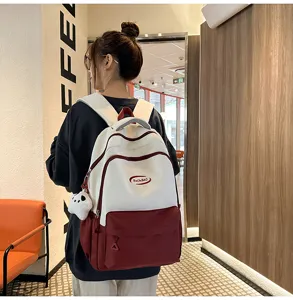 Detail view showcasing the stylish color-block student backpack in a real usage scene.