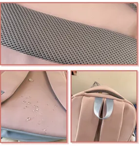 Pink backpack detail close-up showcasing breathable mesh shoulder strap and water-resistant fabric.