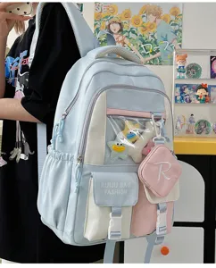 Detailed close-up view of the light blue ita backpack featuring a clear window and plush toys.