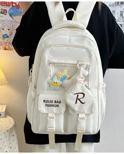 Detail shot of white student backpack with transparent front pocket and cute plush star charms.