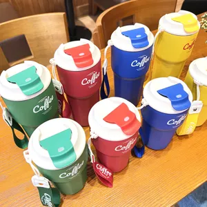 Portable stainless steel insulated coffee cup with secure lid and strap for daily travel use.
