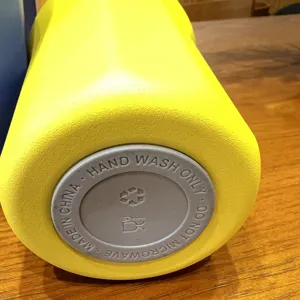 Stainless steel vacuum insulated water bottle bottom detail close up showing care instructions.