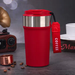 Close-up view of a vibrant red stainless steel insulated coffee tumbler with a carry strap.