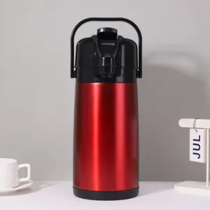 Detailed close-up view of the red stainless steel thermal air pot with pump dispenser.