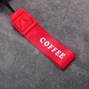 Red coffee cup carrying strap detail view, portable stainless steel thermos accessory.