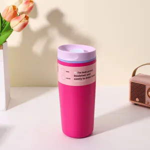 Pink stainless steel insulated travel coffee cup with purple lid and portable leakproof design.