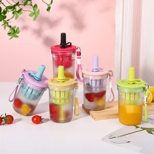 Detail shot of colorful plastic fruit tea cups with straw and infuser, stylish portable design.