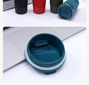 Stainless steel double wall vacuum insulated coffee travel mug with leak-proof lid and non-slip grip.