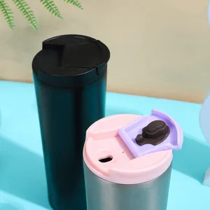 Close-up detail of double wall stainless steel travel coffee mug with colored lid.