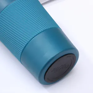 Stainless steel vacuum insulated travel coffee mug with non-slip silicone sleeve and secure lid.