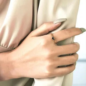 Gros plan d'une bague à bande ondulée plaquée or 18 carats avec motif de verrou Ruyi