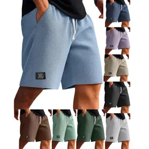 Detail view of men's waffle knit shorts featuring adjustable drawstring waist and utility pockets.