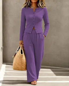 Women's solid color knit button-up long sleeve cardigan and wide-leg pants lounge set.