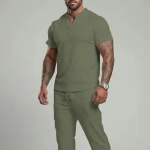 Detail view of men's olive green V-neck short sleeve top and matching pants casual summer set.
