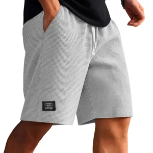 Men's grey waffle knit casual shorts with drawstring and pockets for summer wear.