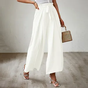 Detailed view of women's white high-waisted wide-leg pants with bow belt and pleated texture.
