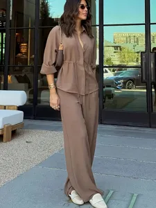 Women solid color long sleeve shirt and wide leg pants two-piece casual suit detail view.