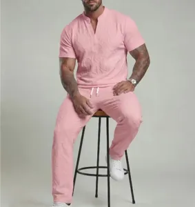 Detail view of men's pink short sleeve V-neck top and matching casual trousers set.