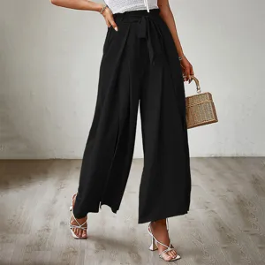 Black high-waist wide-leg pants detail, elegant bow tie waist and pleated texture view.