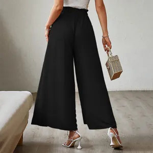 Back view detail of women's black high-waist pleated wide-leg pants with textured fabric.