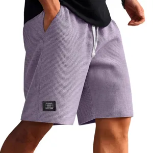 Men waffle knit casual shorts with drawstring and patch detail, comfortable summer beach wear.