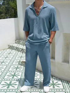 Textured short sleeve shirt and long pants set worn outdoors, casual men clothing detail.