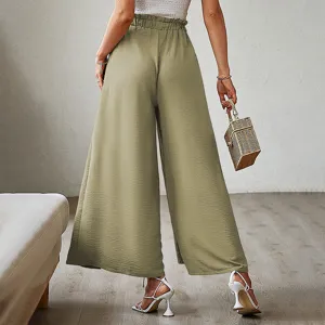 Detailed back view of casual olive green high waisted pleated wide leg pants worn indoors.