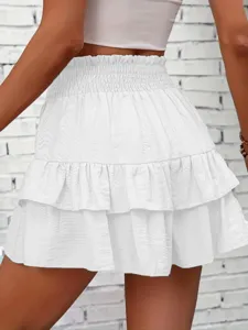 White tiered ruffle mini skirt with smocked high waist, casual summer streetwear fashion apparel.