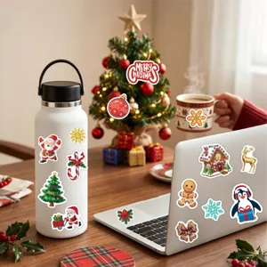 Close-up of festive Christmas cartoon stickers applied to a water bottle and laptop