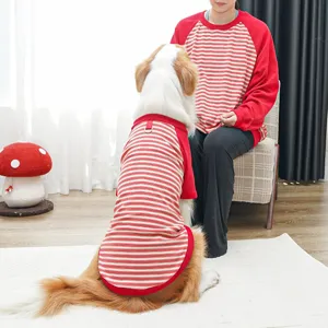 Cute matching striped dog and owner shirts, comfortable red and white crew neck pet apparel detail.