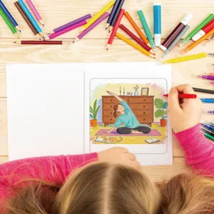 Child hand coloring a yoga illustration in a 24-page relaxation coloring book for girls.