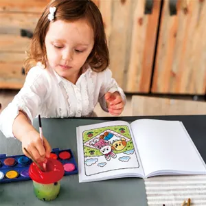 Child using watercolor to color a cute animal picnic scene in a cartoon coloring book