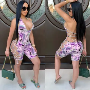Sexy halter lace-up cutout jumpsuit detail, money print design, backless clubwear style.