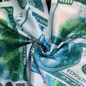 Detailed close-up view of trendy US dollar print fabric with realistic banknote pattern texture.