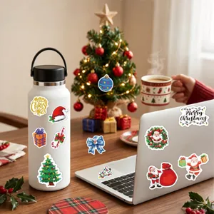 Festive Christmas stickers featuring Santa and tree designs on a laptop and water bottle