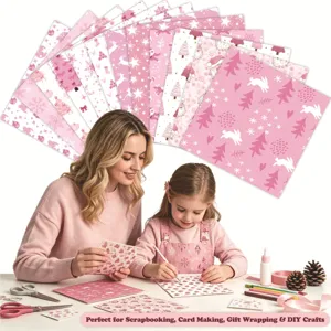 Detailed shot of mother and child using pink Christmas themed DIY craft paper for scrapbooking