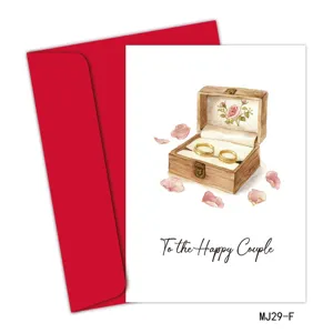 Tarjeta de boda con sobre rojo y texto To the Happy Couple con ilustración de anillos