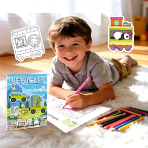 Young boy happily coloring a foldable vehicle-themed educational coloring book on a soft white rug