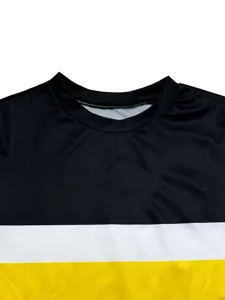 Detailed view of women's black, white, and yellow color-blocked crew neck long sleeve top.