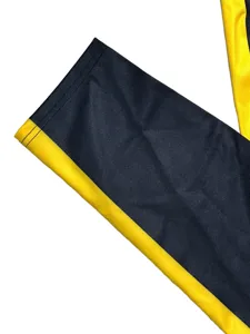 Black and yellow striped apparel detail shot, soft fabric and neat stitching design.