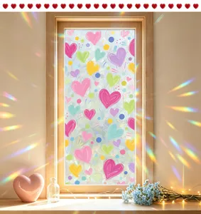 Close-up of heart patterned static window film with rainbow prism light effects