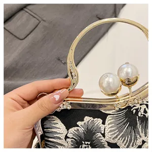 Close-up detail of elegant Chinese style floral embroidered bag with pearl clasp