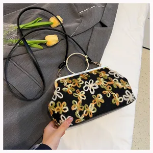 Close-up of vintage floral sequined velvet handbag featuring an elegant metal ring handle