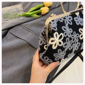 Detailed close-up view of vintage floral velvet handbag with gold ring handle and sequins