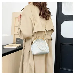Detailed view of a vintage floral silk crossbody phone bag with pearl and gold chain