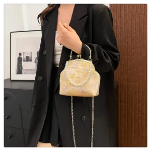 Elegant floral silk handbag featuring pearl handle and gold chain strap in Hanfu style.
