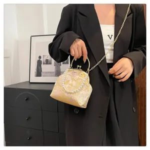Detailed shot of a silk floral handbag with pearl handle and golden chain strap