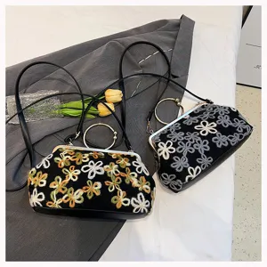 Two luxury vintage velvet evening bags with floral embroidery and gold metal handles